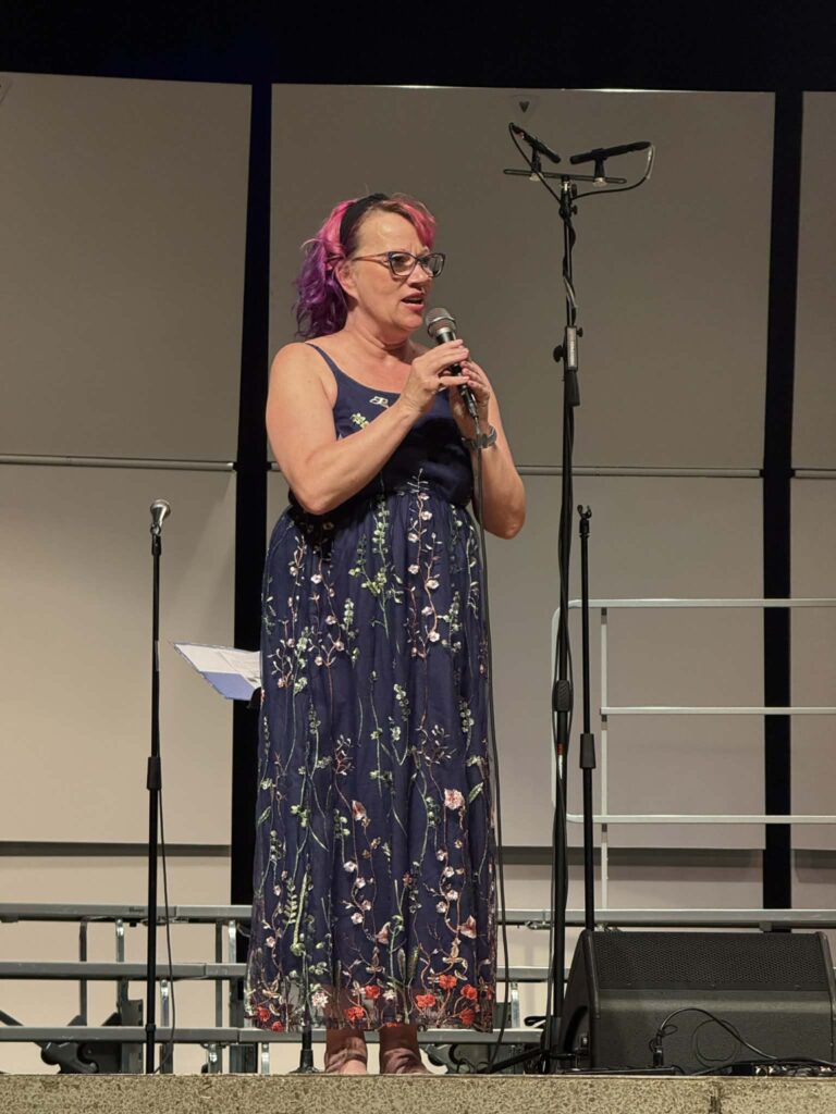 Marie Hayden, speaking at a CPRC concert.