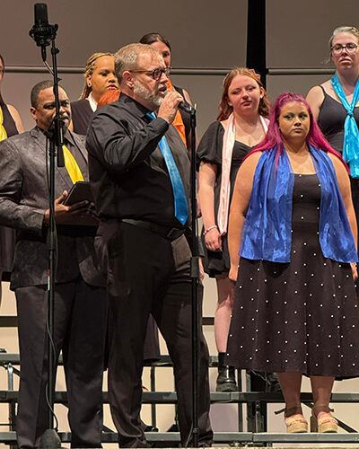 A singer singing a solo in front of the choir